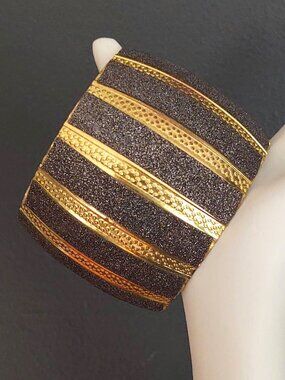 Wide gold cuff with textured sparkly gray panels